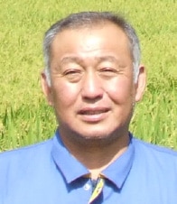 生産者 梅津賢一さんの顔写真