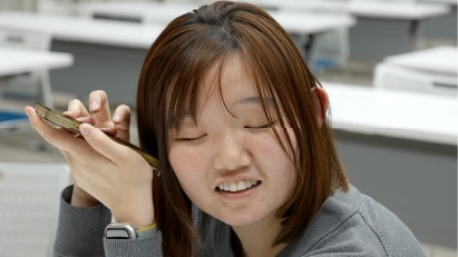 画像：参加者がスマートフォンでWEBサイトの読み上げ機能を検証している様子　画像おわり