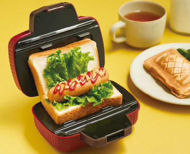 ホットサンドメーカーにパンとソーセージをセットしている様子の画像