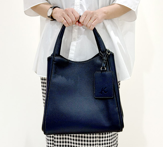 セミショルダーバッグの左右のマチをたたんで小さく持った様子